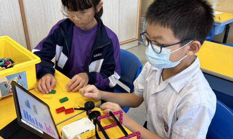 學生專注地進行測試、調整和優化程式，使機器人能按照指示移動和執行任務